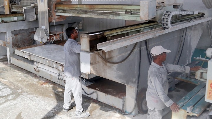 Experienced technicians operating high-precision CNC stone cutting machinery at Lamea Al Rukham